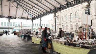 Customer at The Book Stops Here stall