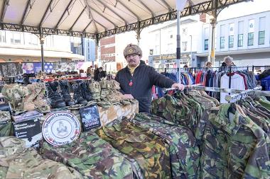 Trader behind military stall