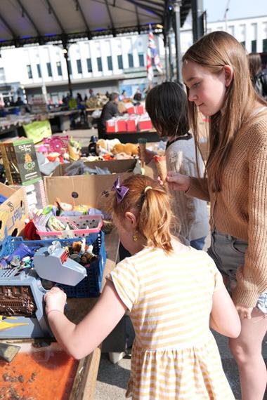 Children browsing through bric-a-brac items