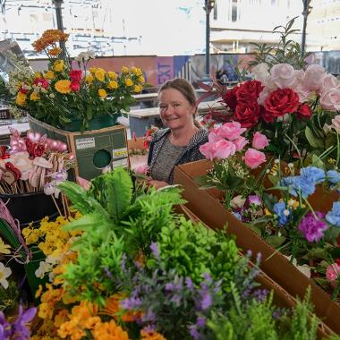 Trader stood with flowers