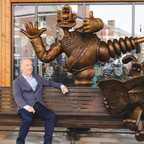 Nick Park sitting on the Wallace and Gromit bench